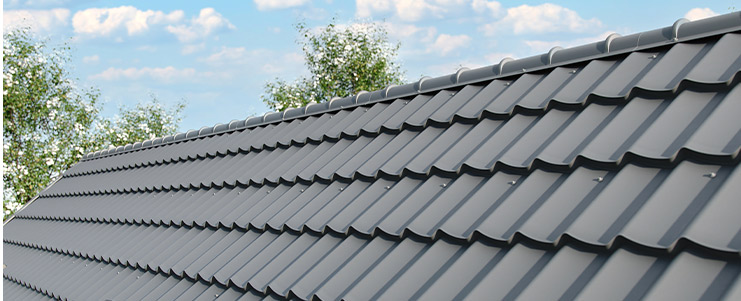Detailed view of a metal roof, featuring a tree behind it, relevant to roofing choices for new homes.