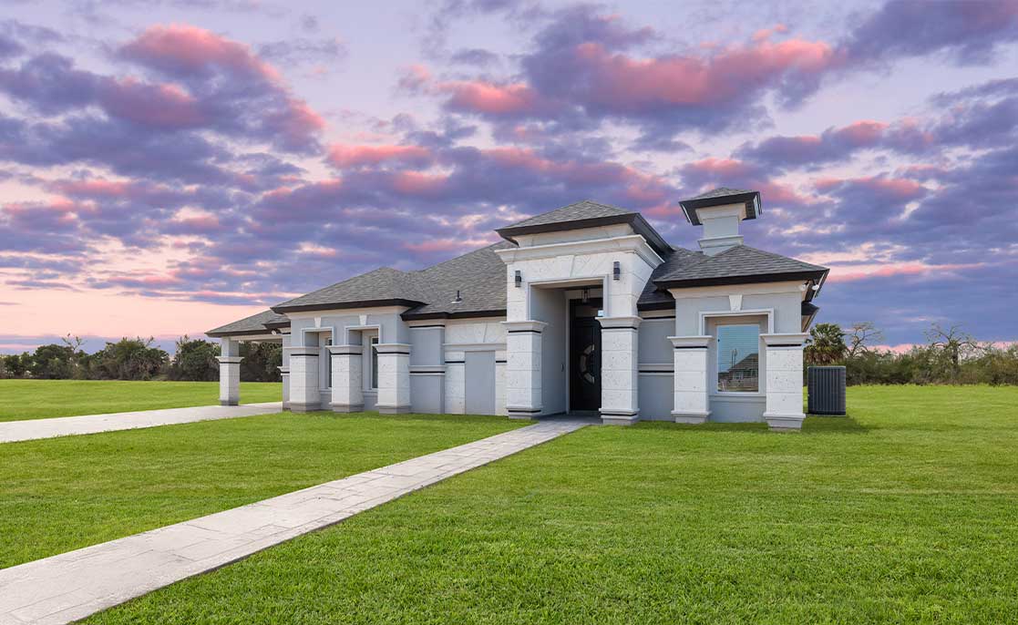 A spacious white house featuring a driveway and lawn, representing a desirable property for new homeowners.